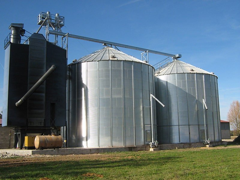 un séchoir à maïs à colonne et deux silos fond plat avec reprise verticale