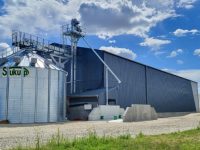 cellule sécheuse sukup agriconsult en extérieur devant batiment avec manutention gamme industrielle et fosse passante avec trémie 3 pentes pré-nettoyeur et ventilateur installation complète cellule sécheuse sukup agriconsult en extérieur devant batiment avec manutention gamme industrielle et fosse passante avec trémie 3 pentes pré-nettoyeur et ventilateur installation complète